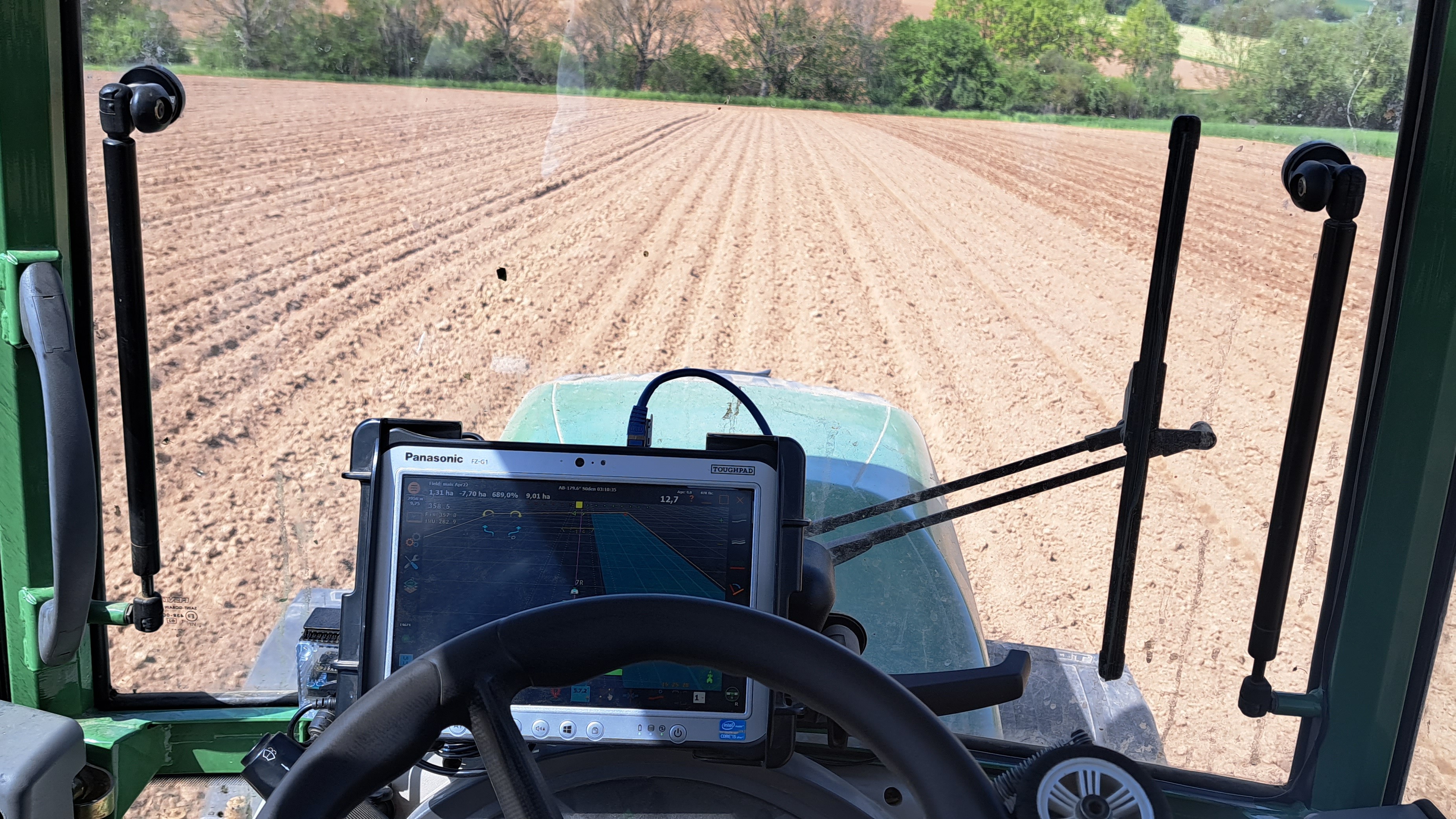 Traktor bei der Bodenbearbeitung mit GPS-Lenksystem für exakte Anschlussfahrten. Auch für ältere Traktoren sinnvoll.